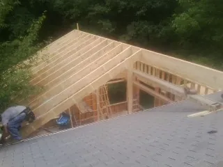 Framing a new roof addition that ties into an existing shingle roof in New Durham