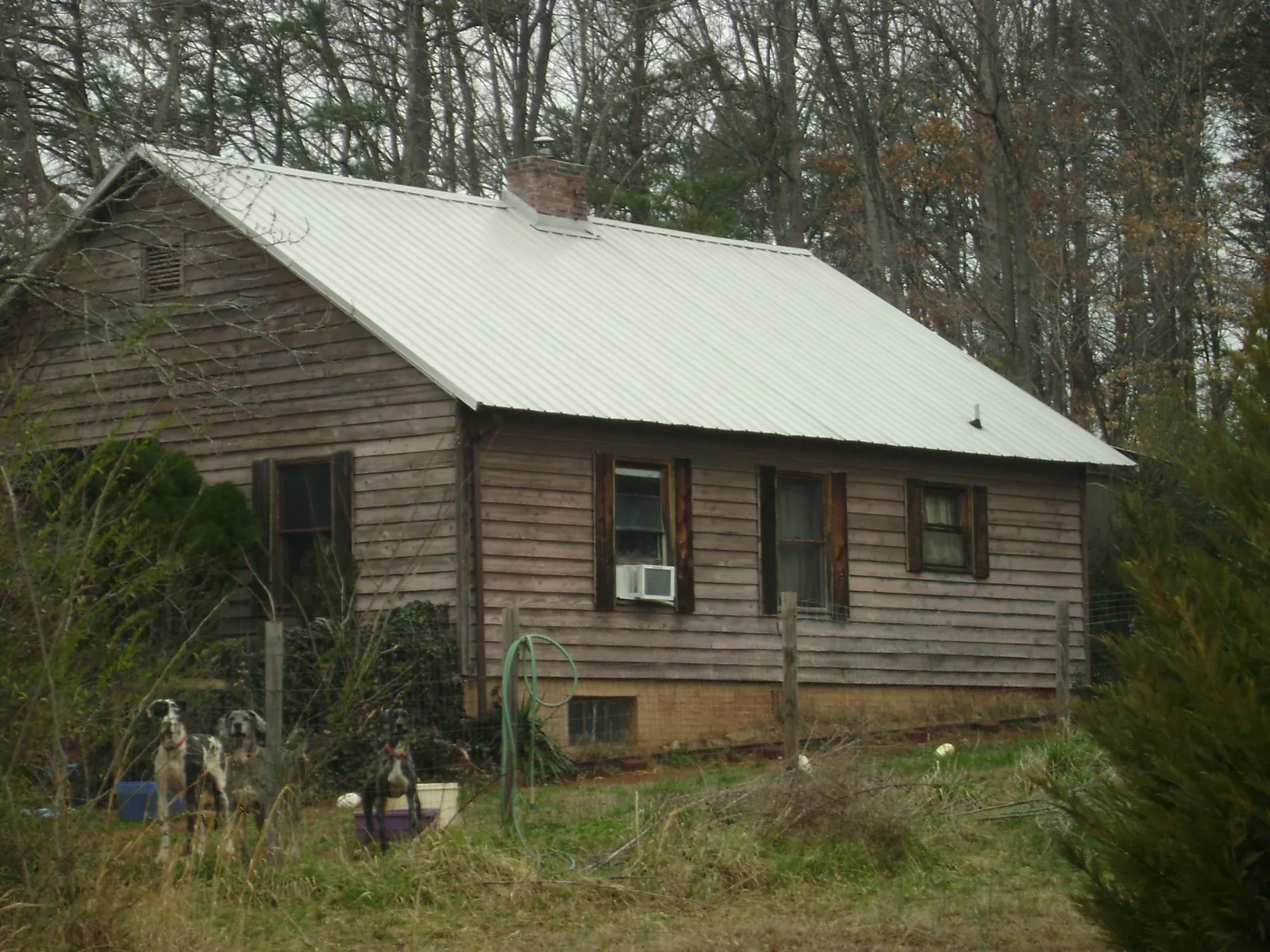 White metal roof on an old wood sided farmhouse, from a Metal Roof Installation job in New Durham